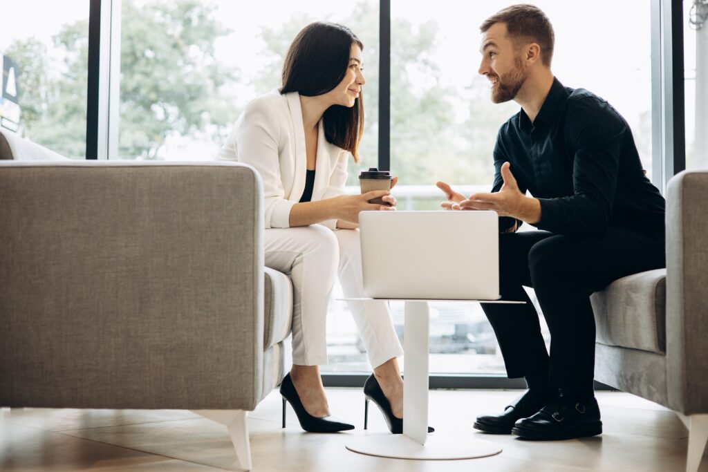 A sales professional meeting with a client in a seemingly positive conversation