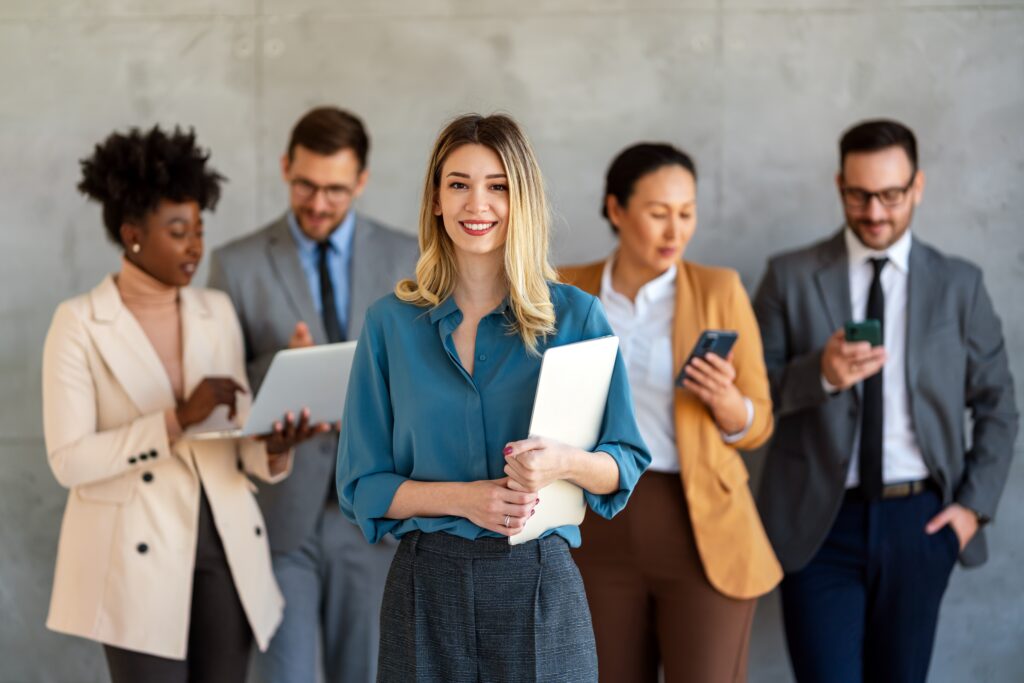 A young business professional looking confident with her colleagues.